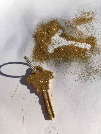 House key painted with glitter.