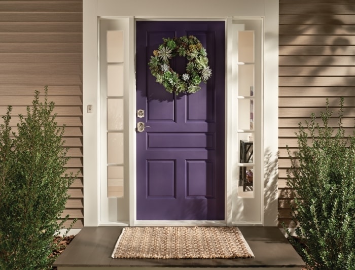 Purple front door with succulent wreath and Schlage deadbolt and keyed lever.