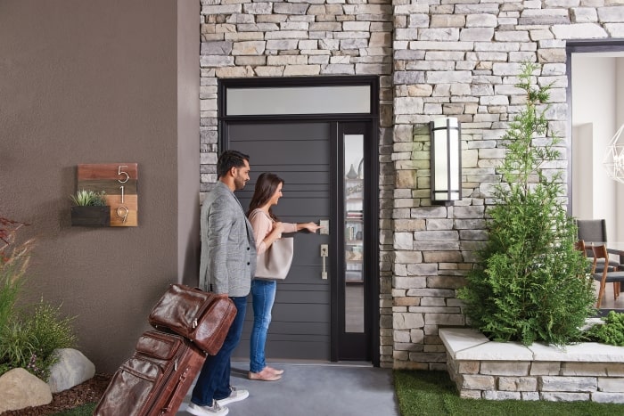 Guests arriving at vacation rental with Schlage smart locks.