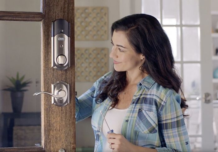 Woman installing Schlage door hardware.