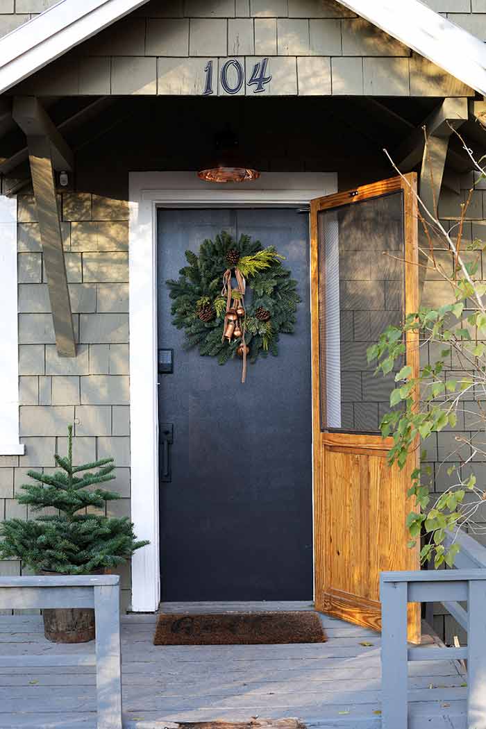 Black front door decorated for the holidays with Schlage Encode lock. 
