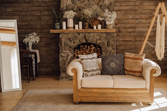 Cozy Bohemian rustic living room with stone fireplace.