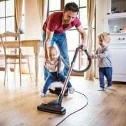 Dad vacuums kitchen with two toddlers | Schlage