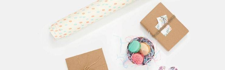Gift wrap, gift boxes and a tin of macarons.