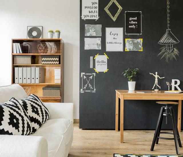Living room with black chalkboard wall.