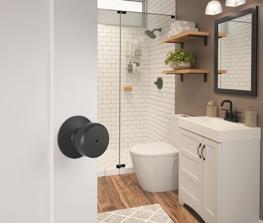Modern bathroom with matte black door knob that locks for privacy.
