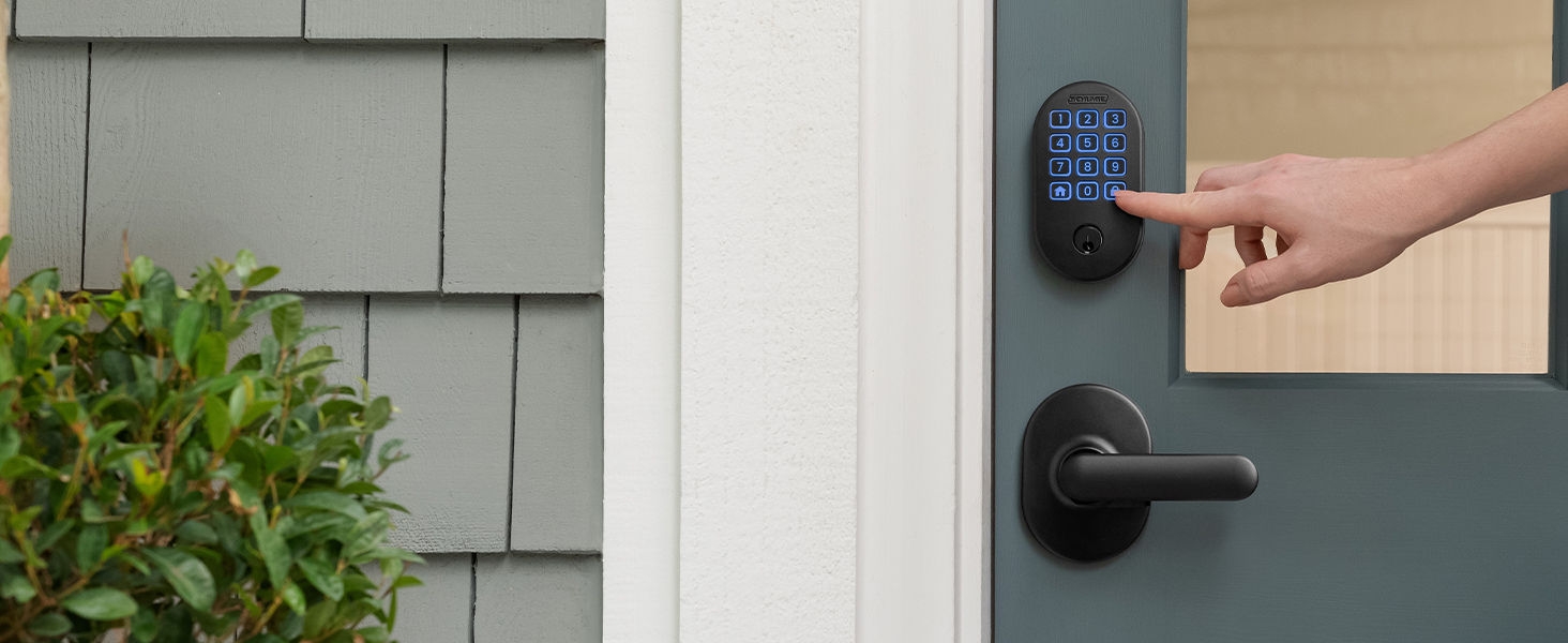 Hand pushing Schlage Arrive smart lock buttons