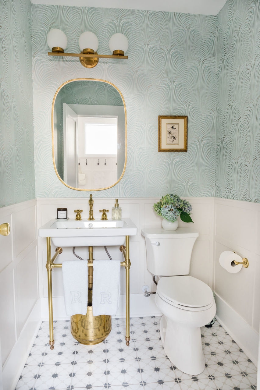 Half bathroom with satin brass metal finishes.