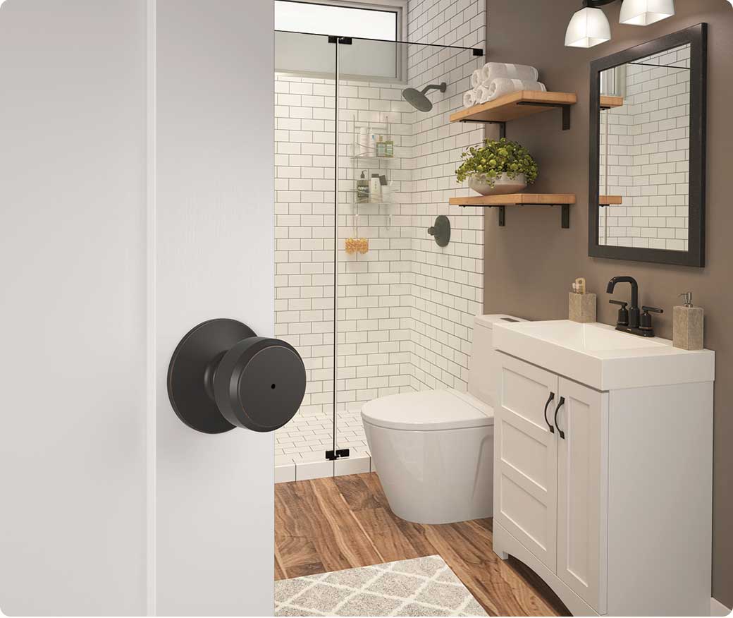 Modern bathroom with matte black door knob that locks for privacy.