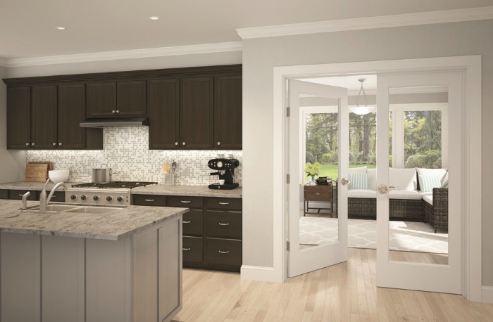 Full glass french doors leading from kitchen to attached sun room with Schlage Accent levers.