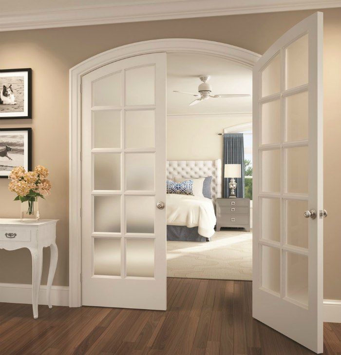 Glass paned french doors leading to bedroom with lockable Schlage Georgian knobs.