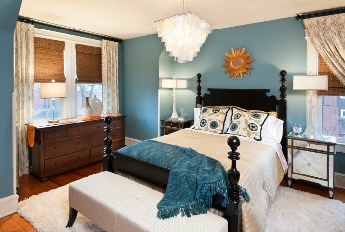 Art deco style bedroom with brass sunburst mirror