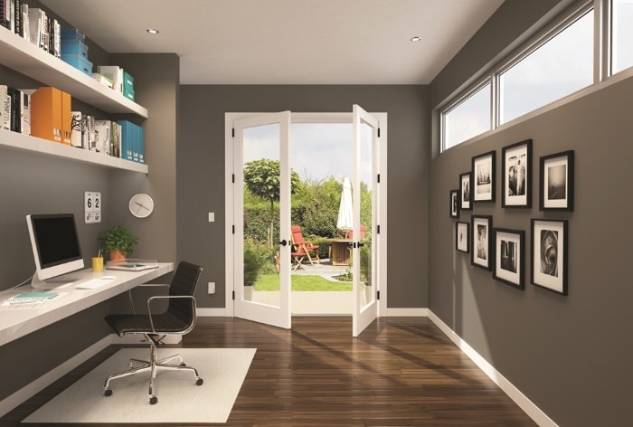 Modern office with french doors leading to outdoor patio.