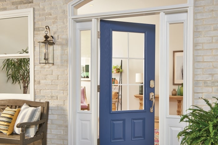 Schlage smart lock in satin nickel on blue front door.