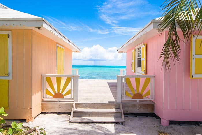 Bright yellow and pink vacation beach homes with curb appeal.
