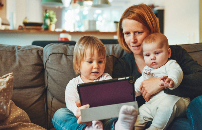 Mom and children looking at tablet.