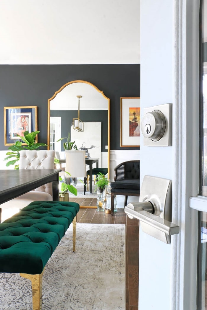 Dining room with large mirror and Schlage door hardware.