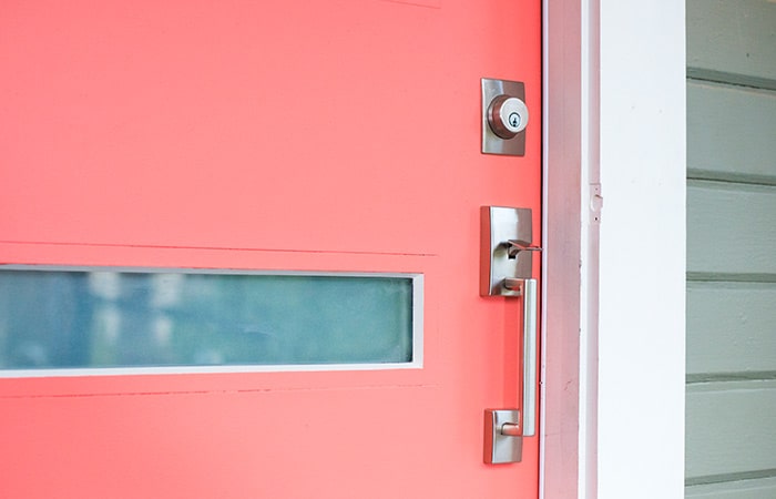 Schlage Century handleset on coral front door.