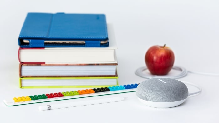 Stack of school books with Google Mini.