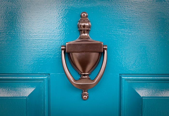 Blue front door with traditional door knocker.