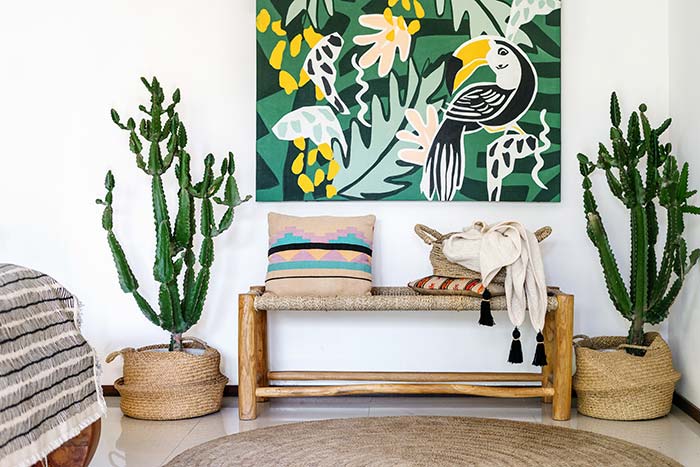 Aztec style entryway bench with large cacti.