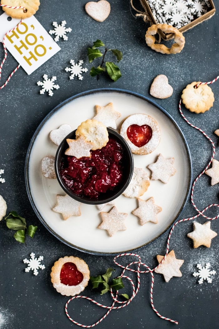 Holiday thumbprint cookies on a plate.