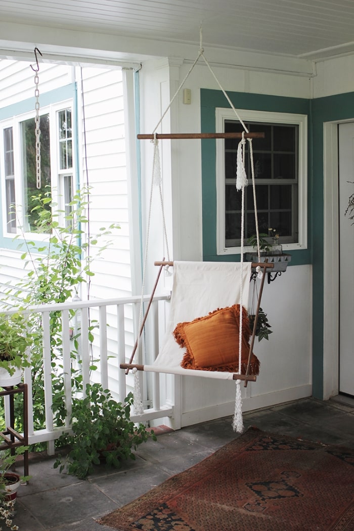 DIY hanging rope chair on front porch.