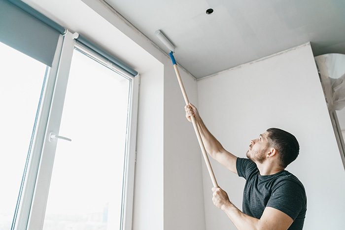 Man painting ceiling.