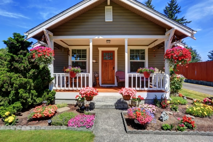 Small craftsman home with bright flowers and curb appeal.