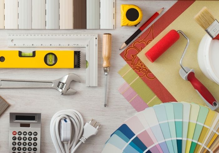 Tools and paint swatches laid out for home remodeling plans.