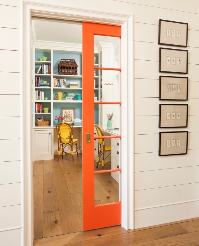 Orange home office pocket door in Farmhouse.
