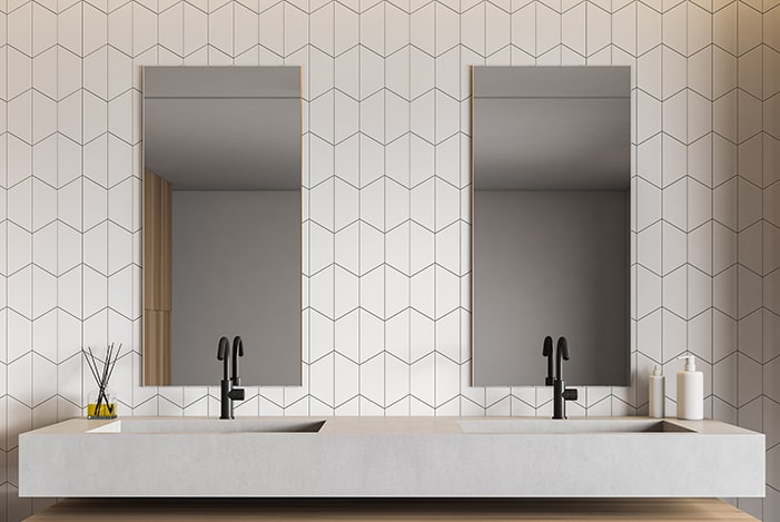 Bathroom with white hex tile walls and concrete vanity.