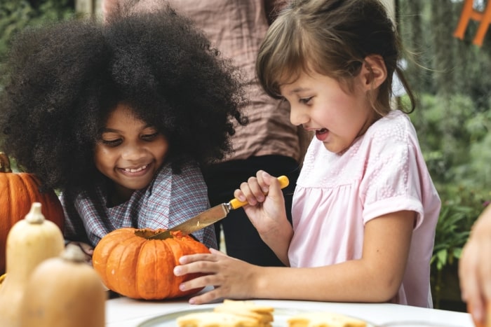 Children carving pumpkins.