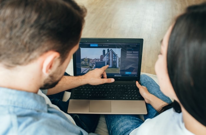 Couple looking at homes online.