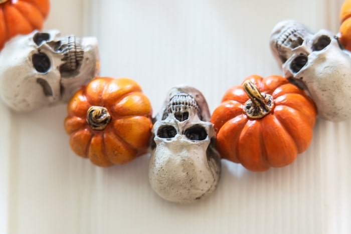 Mini pumpkin and skull Halloween wreath.