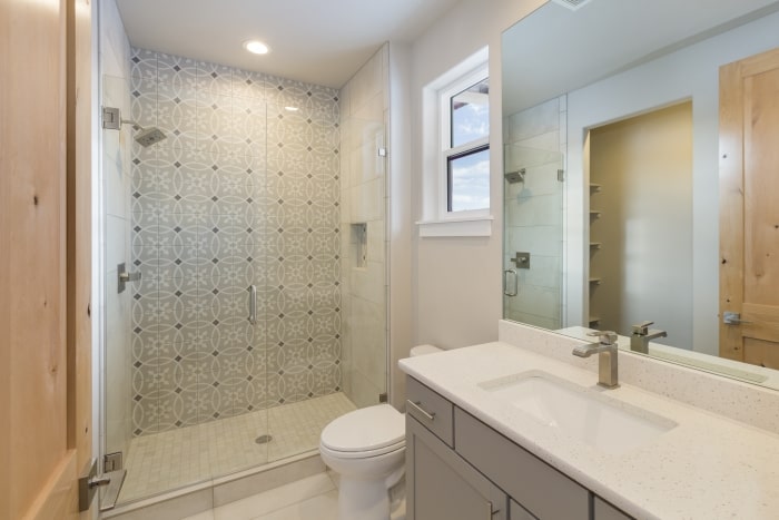 Modern farmhouse bathroom with glass shower.