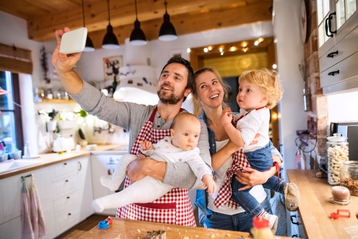 Family baking for Christmas and taking a group selfie.