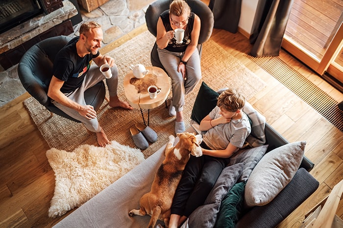 Family sitting in living room talking.