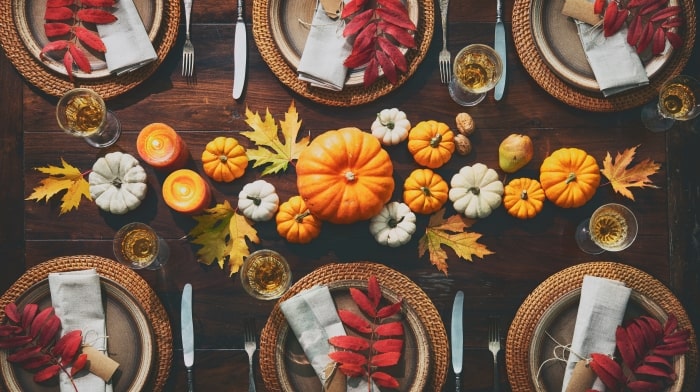 Thanksgiving table with pumpkins as centerpiece.