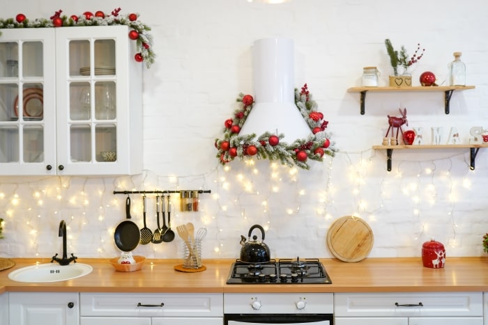 White kitchen decorated for Christmas.