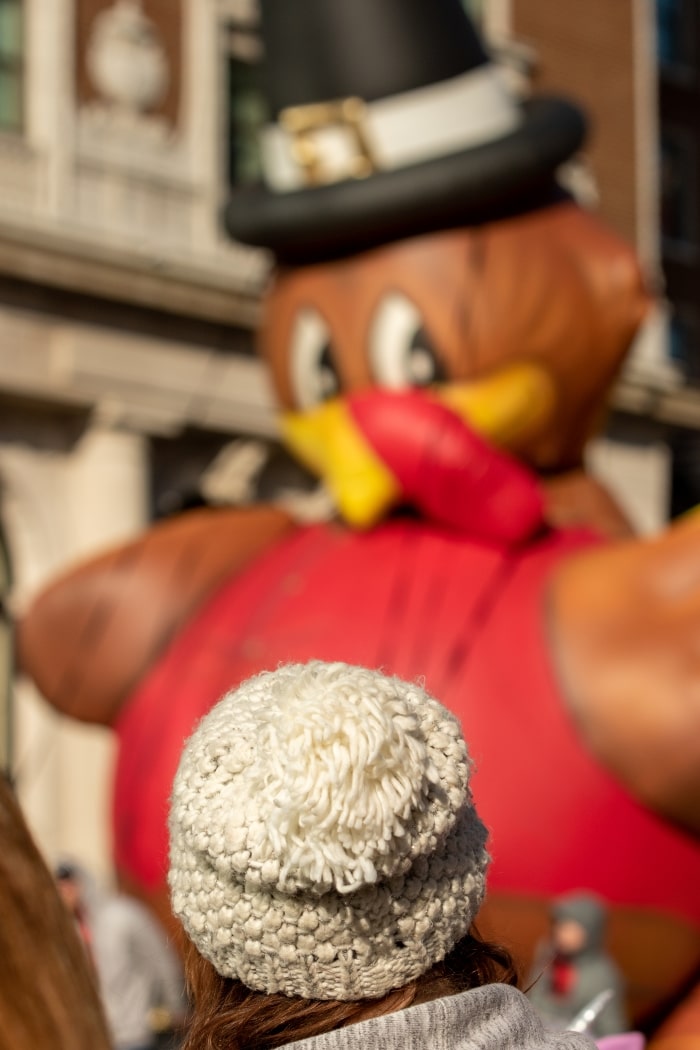 Woman watching Thanksgiving Day parade.