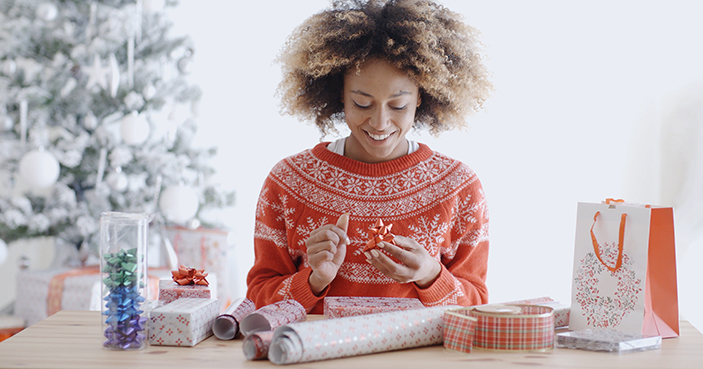 Woman wrapping Christmas presents.