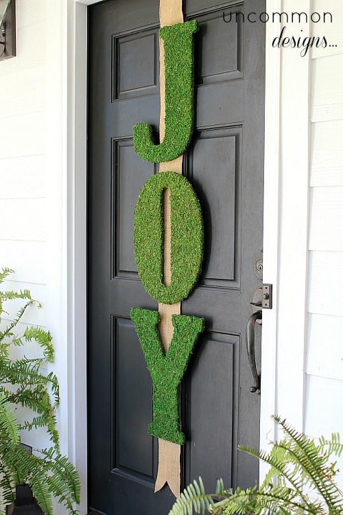 Moss covered joy letters on front door.