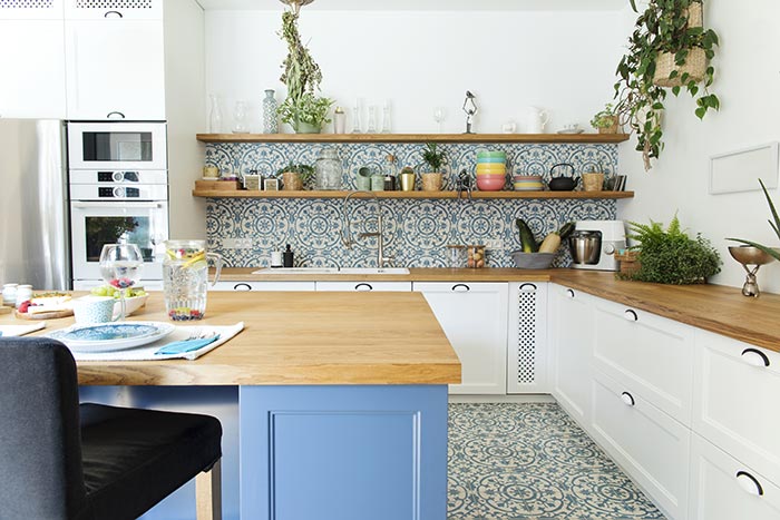 Bright kitchen with Mediterranean inspired tile floor and backsplash.