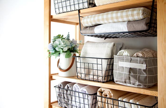 Storage rack with organized linens.