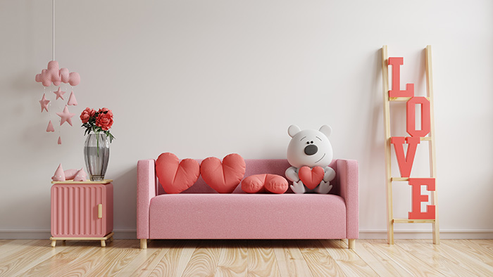 Pink couch with Valentine's Day decor.