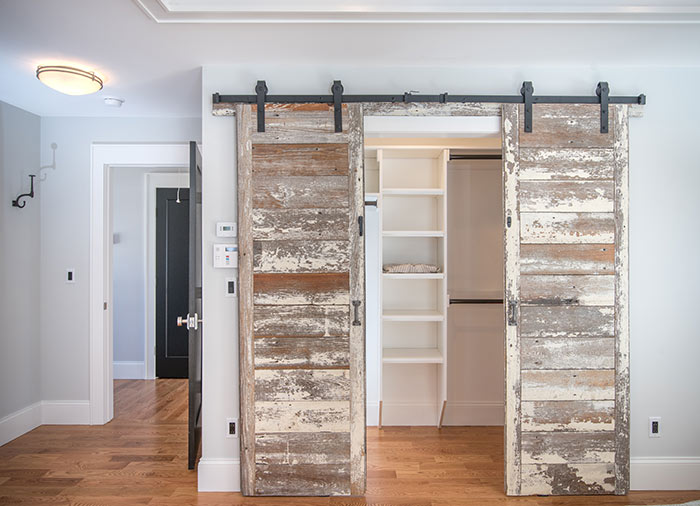 Reclaimed wood sliding barn door closet doors.