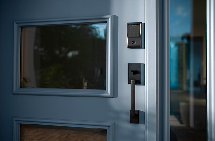 Schlage Encode wifi smart lock in Matte Black on blue front door.