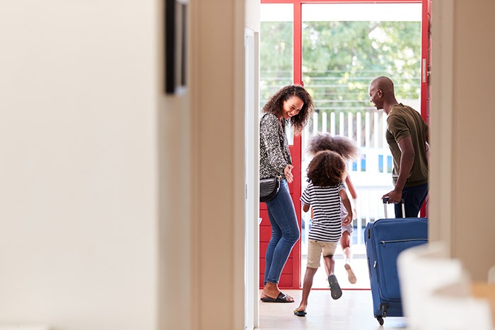 Excited family leaving home for vacation.