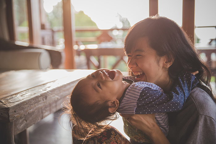 Mother and child laughing and playing.